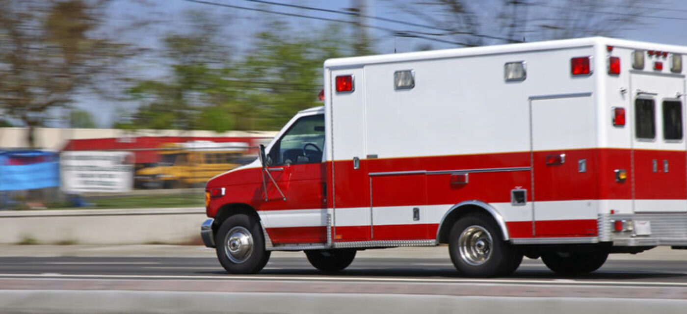 Ambulance moving at high speeds down a town road