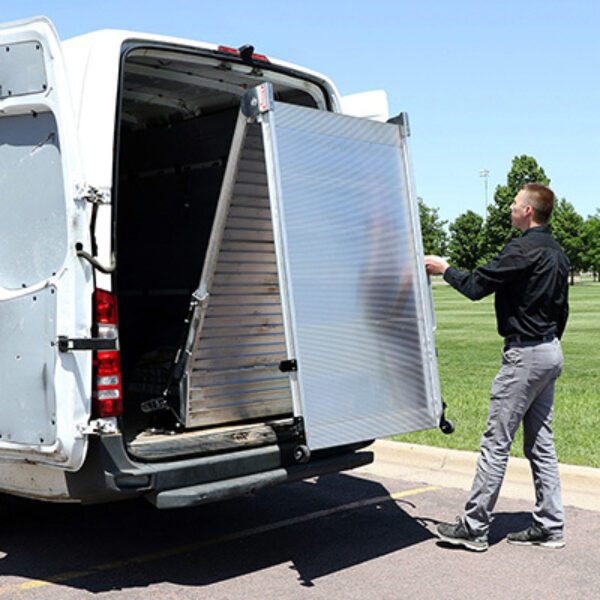 Man deploying LB20 ramp from rear of cargo van.