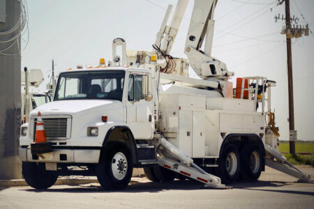 A crane truck with its crane extended equipped with an Air Link Tandem Drive Suspension