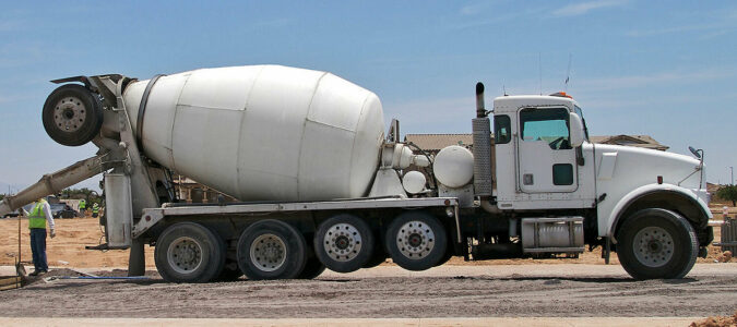 A cement mixer with two visible steerable auxiliary suspensions