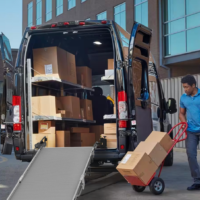 A delivery driver loading a Ram Promaster using a Link Swivel Ramp