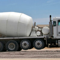 A cement mixer with two visible steerable auxiliary suspensions