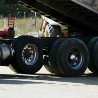 Tires on a dumping dump truck, including a non steer lift axle