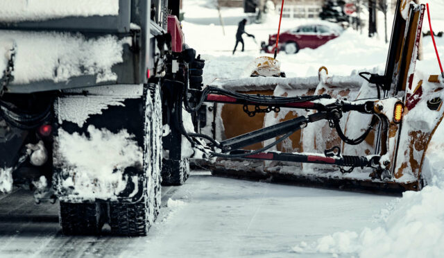 Snow plow truck plowing snow off the road