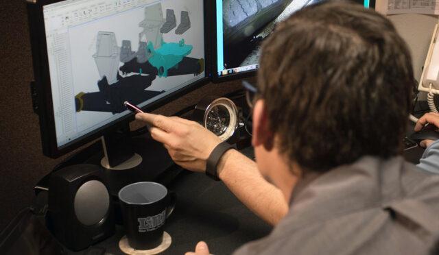 Two people looking at Air Link rendering on computer screen