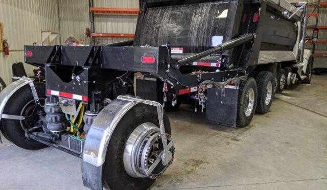 Testing equipment on dump truck trailing axle