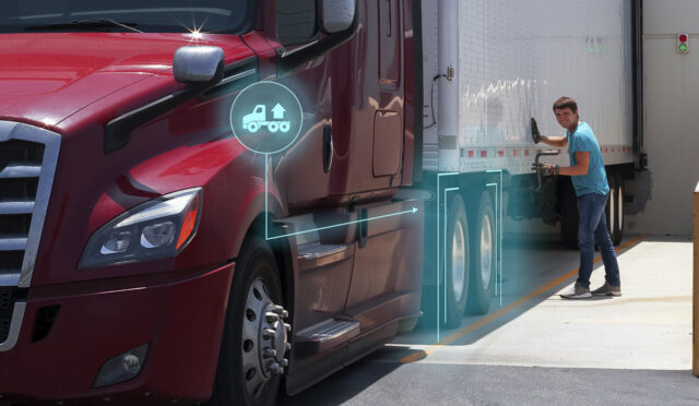 Man smiling as he cranks the landing gear of a trailer connected to a tractor equipped with SmartValve