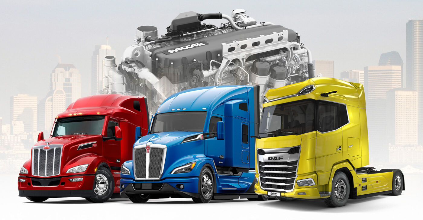 Three semi truck cabs lined up, one red, one blue, and the third yellow