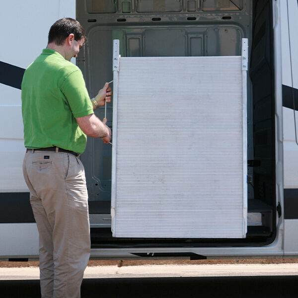 Man deploying LB10 side door mount ramp