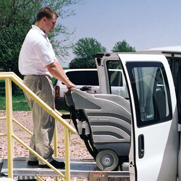 Man loading equipment over stairs using LB10 side-door mount ramp