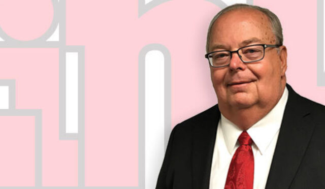 A phot of Denny Michels in front of a Link Logo