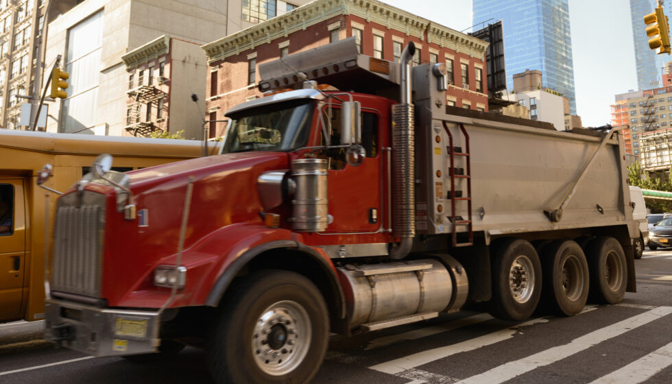 A dump truck on city streets.